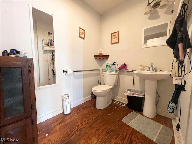 bathroom featuring wood-type flooring and toilet