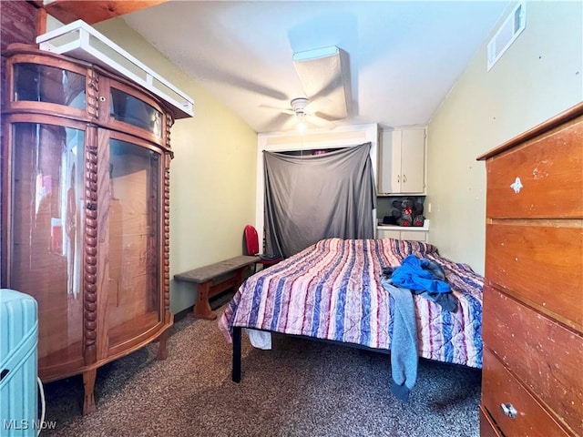 bedroom with ceiling fan and dark carpet