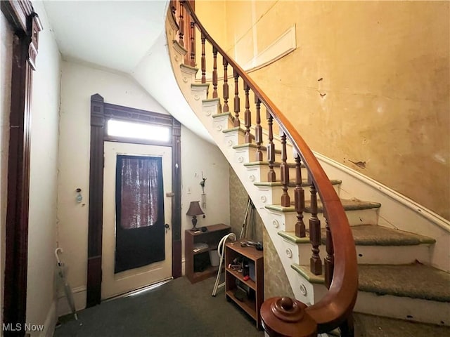 stairs featuring lofted ceiling