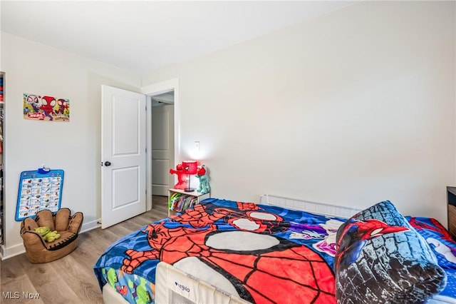 bedroom with hardwood / wood-style floors