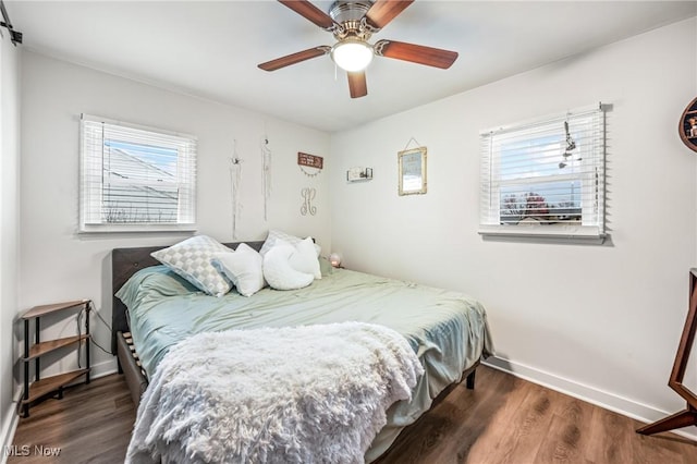 bedroom with dark wood-type flooring and ceiling fan