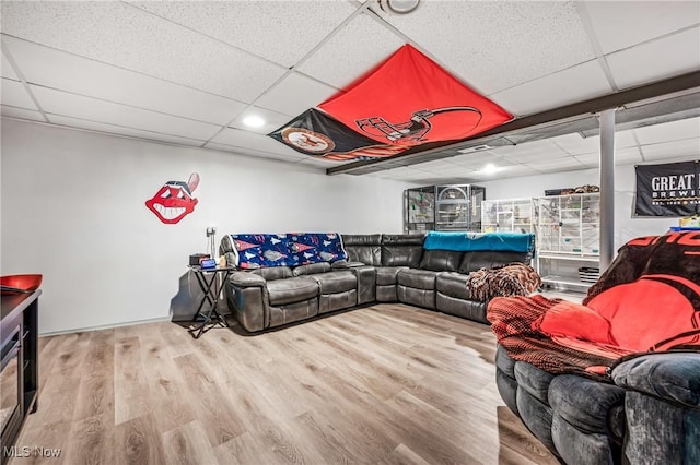 living room featuring hardwood / wood-style flooring and a drop ceiling