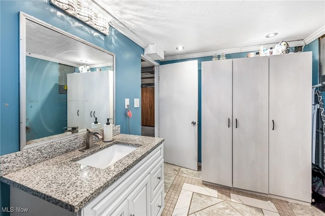 bathroom with tile patterned flooring, vanity, and ornamental molding