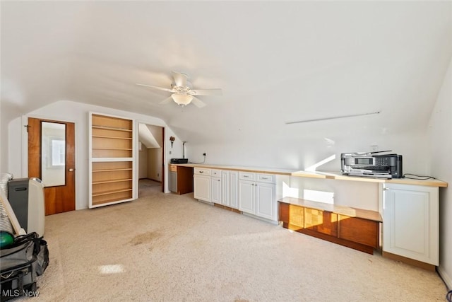 additional living space with ceiling fan, vaulted ceiling, and light carpet