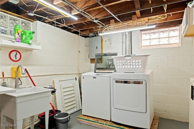 clothes washing area featuring sink, washing machine and clothes dryer, and electric panel