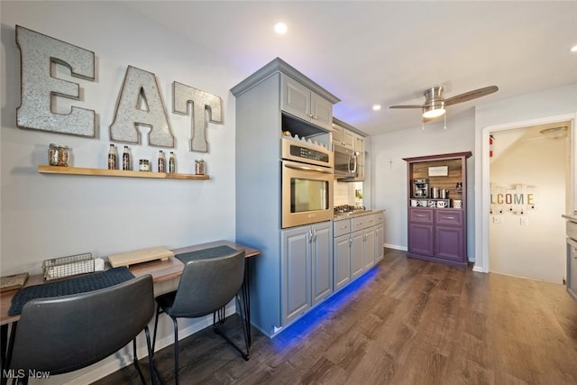 kitchen featuring ceiling fan, stainless steel appliances, dark hardwood / wood-style flooring, and gray cabinets