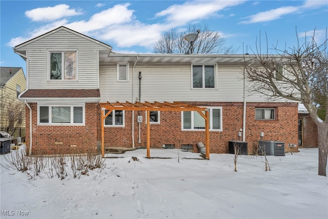 snow covered house featuring central air condition unit