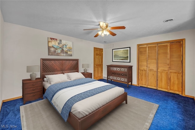 carpeted bedroom featuring a closet and ceiling fan