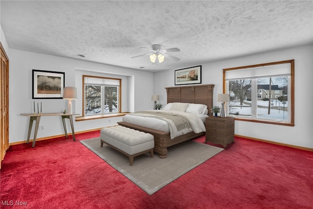 bedroom with multiple windows, carpet floors, and a textured ceiling