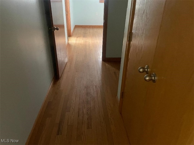 corridor with light hardwood / wood-style flooring