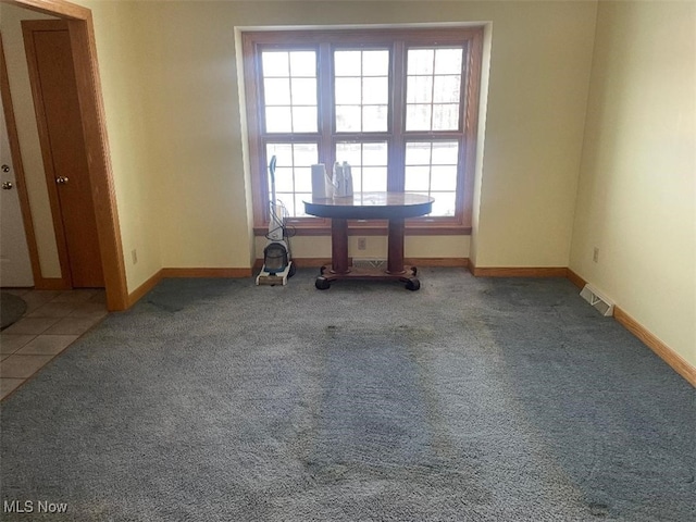 unfurnished room featuring carpet and plenty of natural light