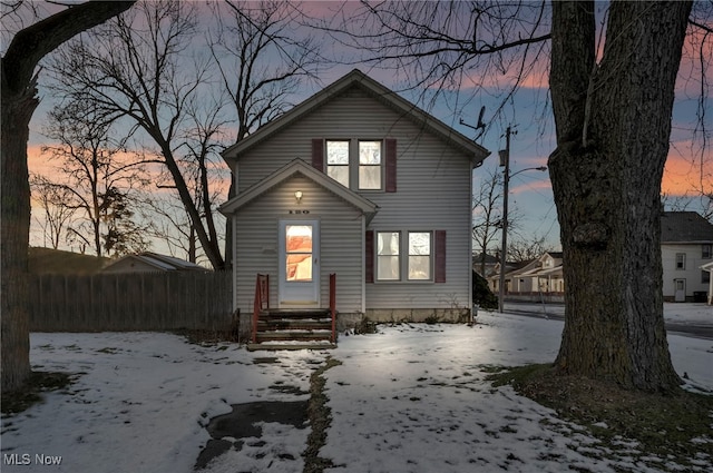 view of snow covered rear of property