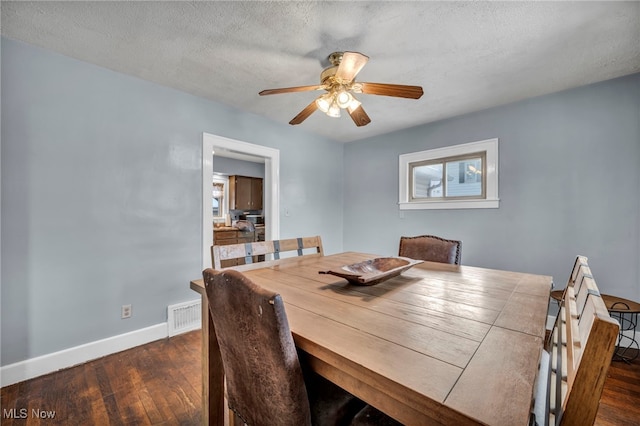 dining area featuring ceiling fan, dark hardwood / wood-style flooring, and a textured ceiling