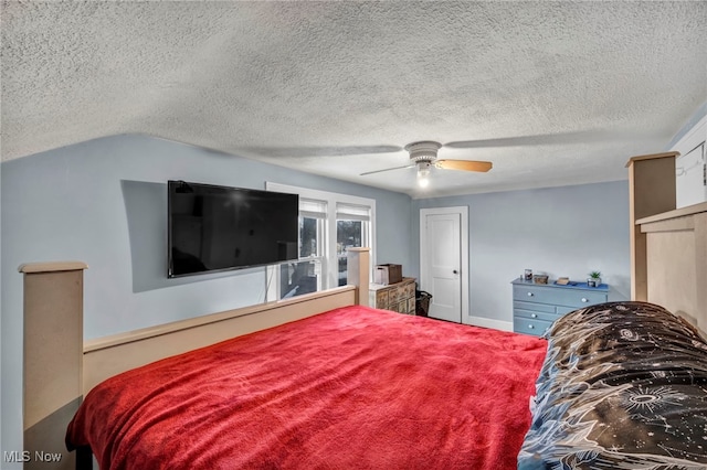 bedroom featuring ceiling fan, lofted ceiling, and a textured ceiling