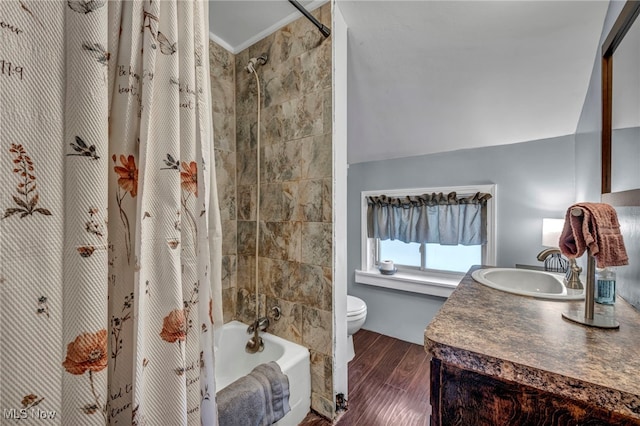 full bathroom with shower / tub combo with curtain, toilet, vaulted ceiling, vanity, and hardwood / wood-style floors