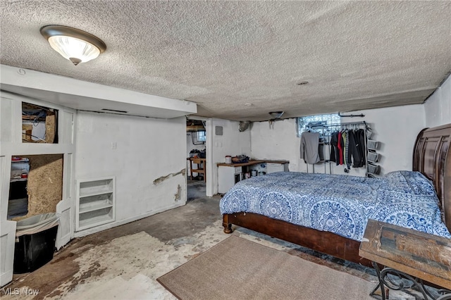 bedroom featuring concrete floors and a textured ceiling