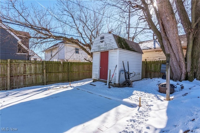 yard layered in snow with a storage unit