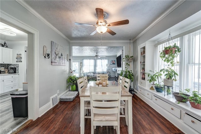 dining space with built in features, ornamental molding, dark hardwood / wood-style floors, and a textured ceiling