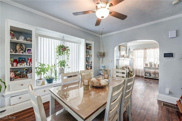 dining space featuring crown molding, ceiling fan, a textured ceiling, and dark hardwood / wood-style flooring