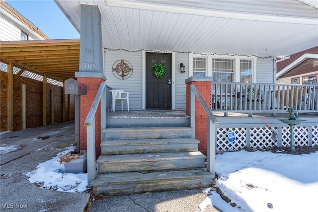 view of snow covered property entrance