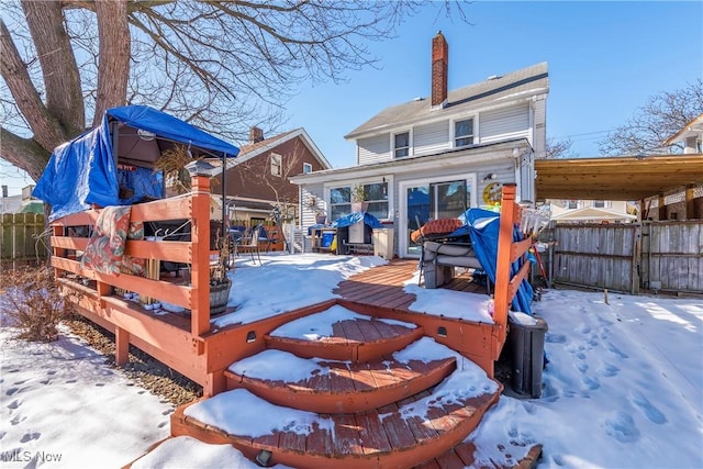 view of snow covered rear of property