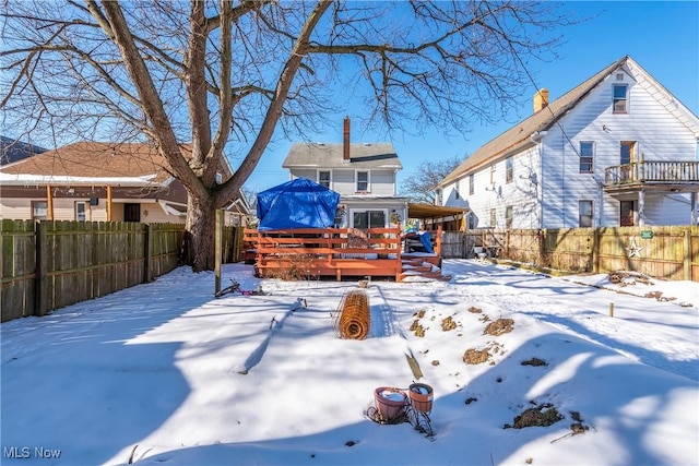 yard covered in snow featuring a wooden deck