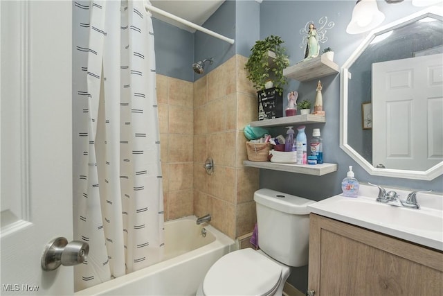 full bathroom featuring shower / tub combo with curtain, vanity, and toilet