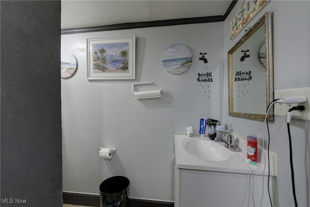 bathroom featuring ornamental molding and vanity