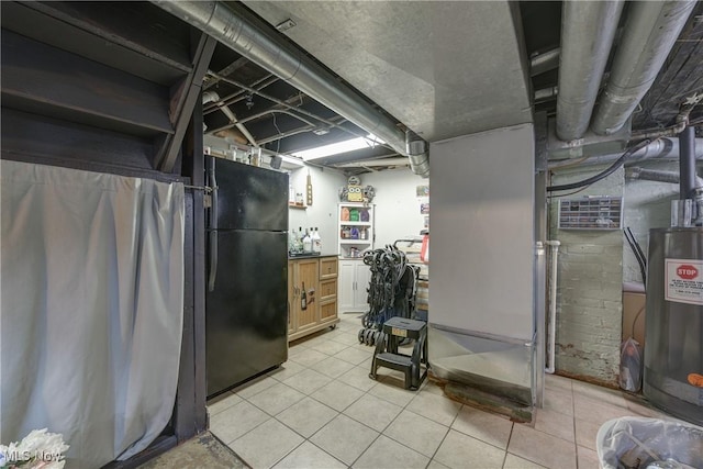 basement featuring light tile patterned floors and black fridge