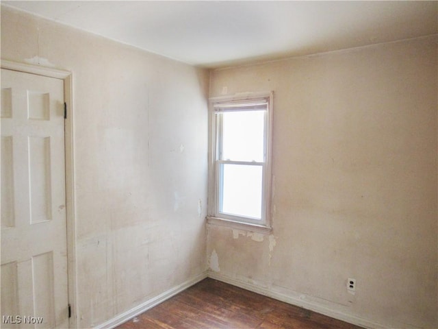 unfurnished room featuring dark hardwood / wood-style flooring