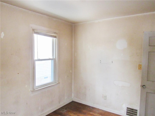 empty room featuring dark hardwood / wood-style flooring