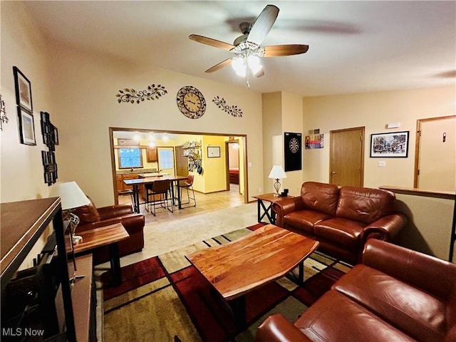 living room featuring vaulted ceiling and ceiling fan