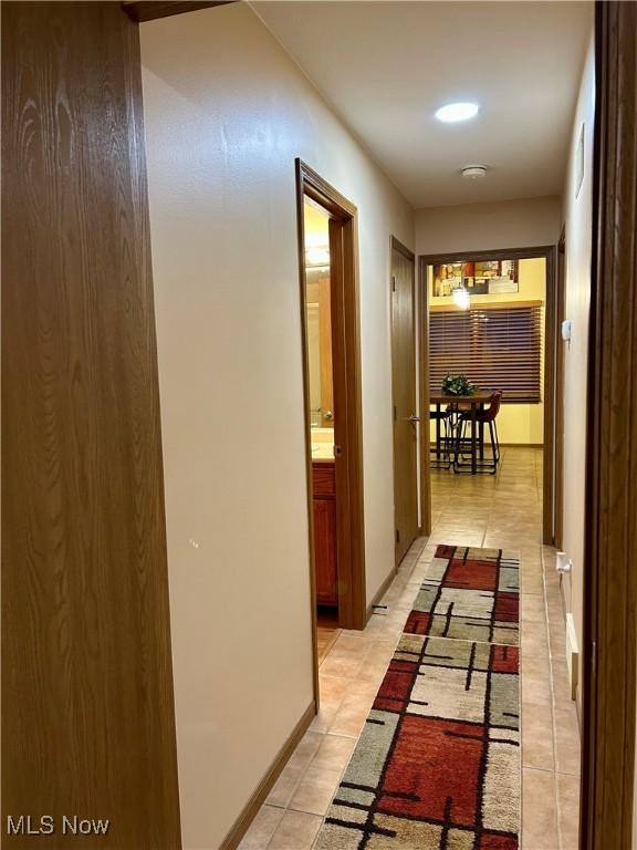 hall featuring light tile patterned floors