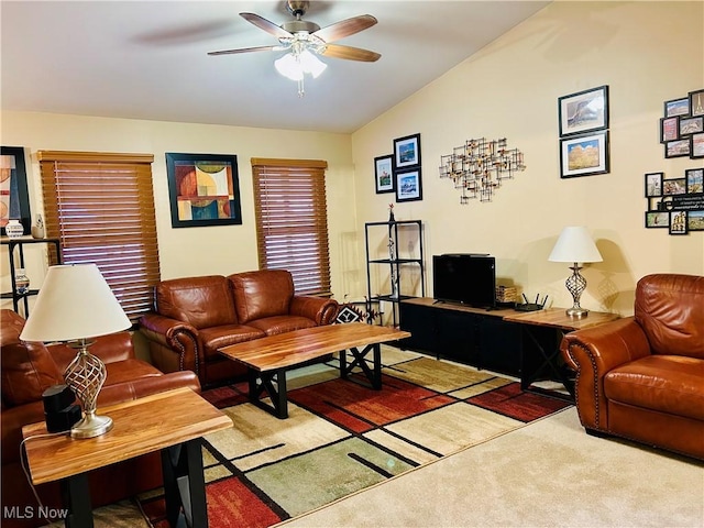 living room featuring ceiling fan, lofted ceiling, and carpet flooring