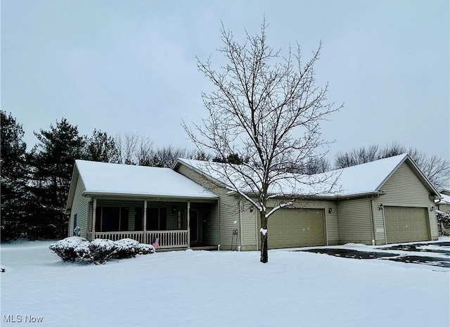 view of front of home featuring a porch and a garage