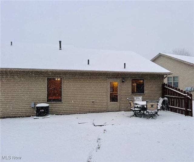 view of snow covered back of property