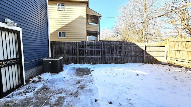 yard covered in snow with central AC