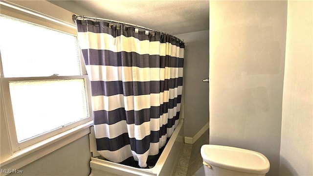 bathroom featuring curtained shower, tile patterned floors, a textured ceiling, and toilet