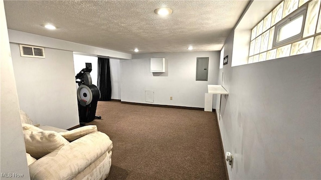 basement with dark carpet, electric panel, and a textured ceiling