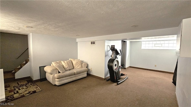 workout room with carpet floors and a textured ceiling