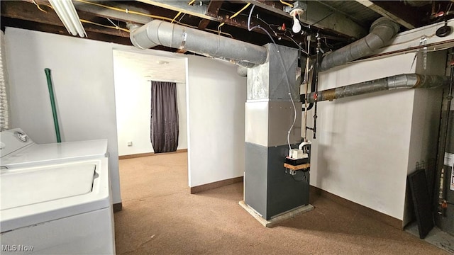 basement with washing machine and dryer and heating unit