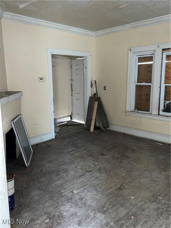 unfurnished living room featuring crown molding