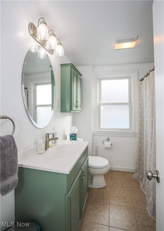 bathroom featuring tile patterned floors, toilet, and vanity