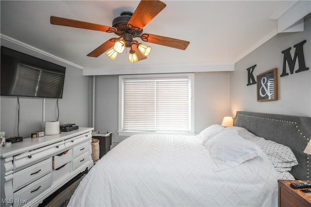 bedroom featuring ceiling fan and ornamental molding