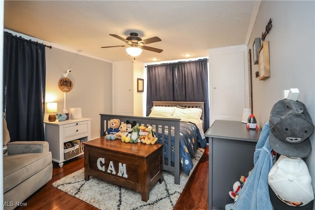 bedroom featuring ceiling fan and dark hardwood / wood-style flooring