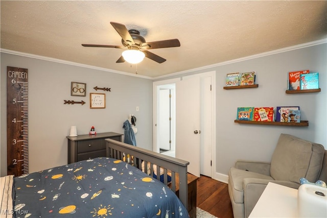 bedroom featuring crown molding, dark hardwood / wood-style floors, and ceiling fan