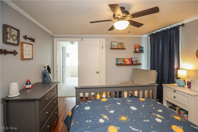 bedroom with crown molding, ceiling fan, dark hardwood / wood-style floors, and a textured ceiling