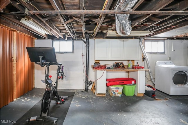 basement featuring a healthy amount of sunlight and washer / clothes dryer