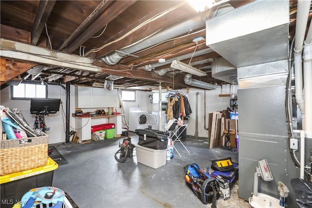 basement featuring washer and dryer and heating unit