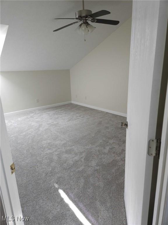 bonus room with lofted ceiling, carpet floors, and ceiling fan